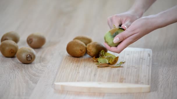 Een Kiwi Peeling Met Een Mes — Stockvideo