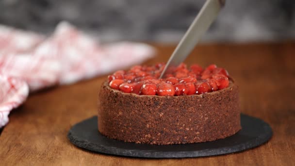 Mãos femininas cortando cheesecake de chocolate com uma faca. Sobremesa doce caseira . — Vídeo de Stock