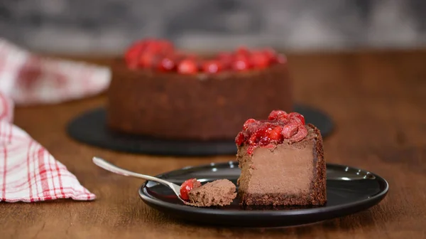 Delicious Piece Of Chocolate Cheesecake with cherry.