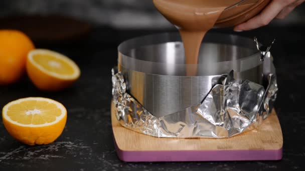 Cooking chocolate mousse cake. Pouring chocolate mousse into a cake ring. — Stock Video