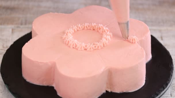 Pastry chef is making a pink cake in the shape of a flower. Series. — Stock Video