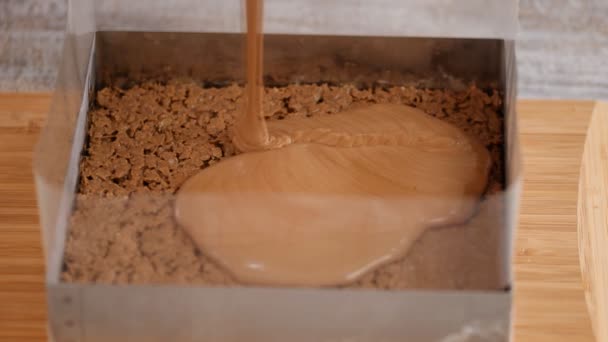 Csokis habot öntök a piskótába. Csokis desszert készítése. — Stock videók