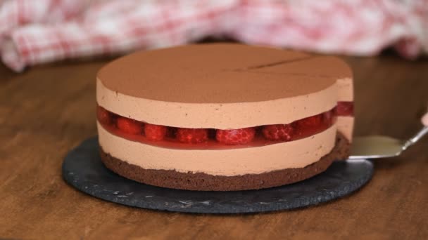 Delicioso pastel de mousse de chocolate con jalea de frambuesas . — Vídeo de stock