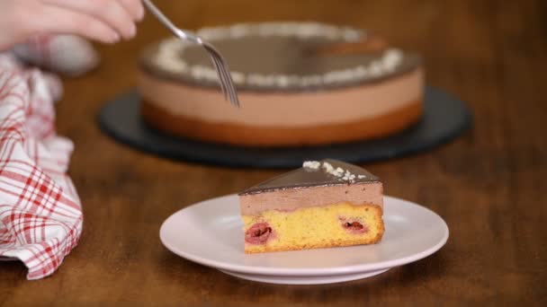 Comendo pedaço de bolo de mousse de cereja de chocolate . — Vídeo de Stock