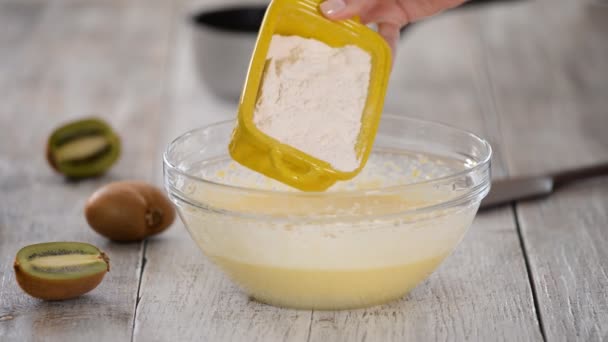 Adding flour to the dough. Chef hands pouring white flour to the dough in bowl. — Stock Video