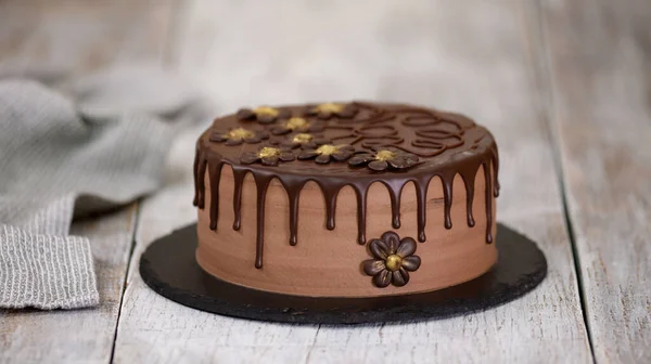 Köstliche Schokoladenkuchen mit Blumen dekoriert. Pflaumenschokoladenkuchen — Stockfoto