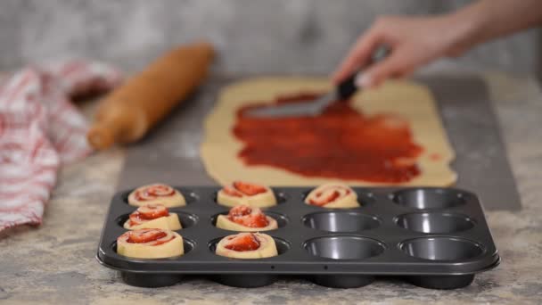 Female hands making buns with berry jam. — Stock Video