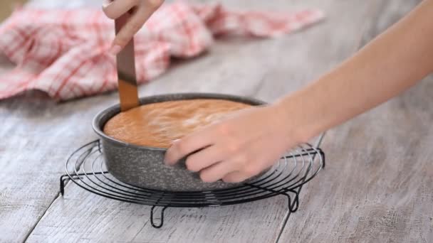 Confectioner taking out of cake from cake mold. — Stock Video