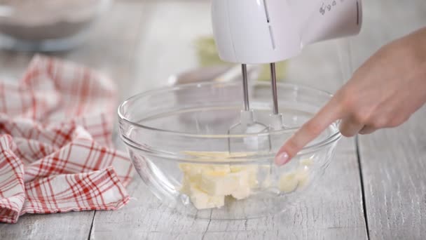 Pastelero batiendo mantequilla blanda con una batidora — Vídeo de stock