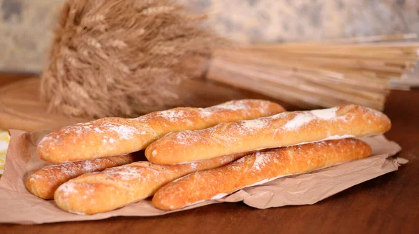 Fresh baguette on wooden table, close up. — Stock Photo, Image