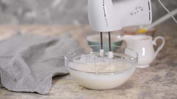 Elektrische mixer slagroom in mengkom. Het maken van room dessert. — Stockvideo
