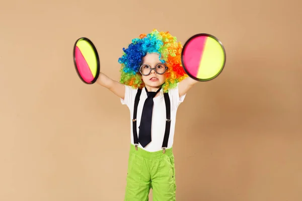 Ragazzo in parrucca clown e occhiali che gioca palla gioco cattura — Foto Stock