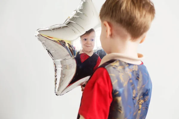 Boy Grimacing Playing Ape Star Shaped Balloons Studio Kid Looks — Stock Photo, Image