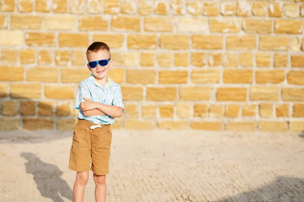 Kleiner Junge mit blauer Spiegelsonnenbrille gegen den gelben BH — Stockfoto