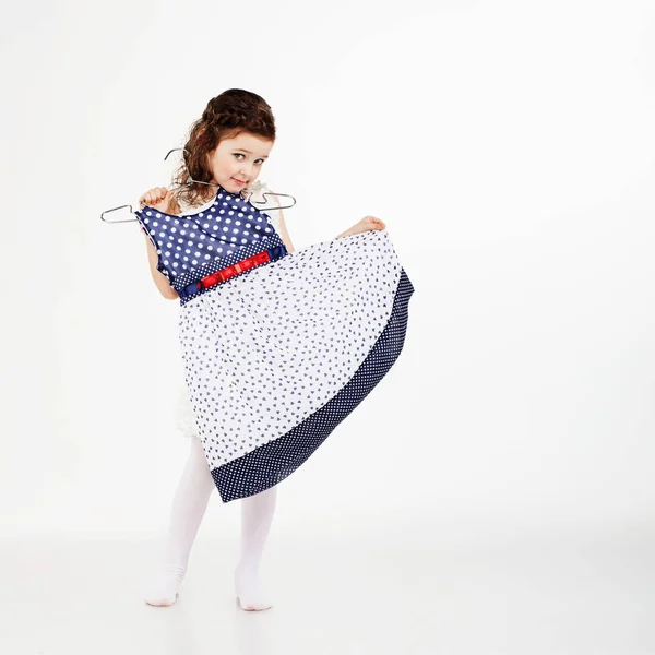 Little girl and clothes hangers shopping — Stock Photo, Image