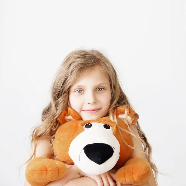 Маленька дівчинка з великим плюшевим ведмедем розважається сміючись Ізольовані на — стокове фото