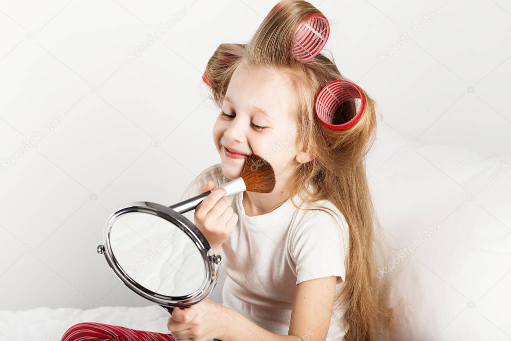 Fashion little girl making up with mirror. Adorable baby girl pl