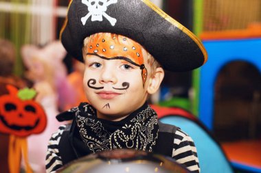 little boy in a pirate costume and a makeup on his face is havin clipart
