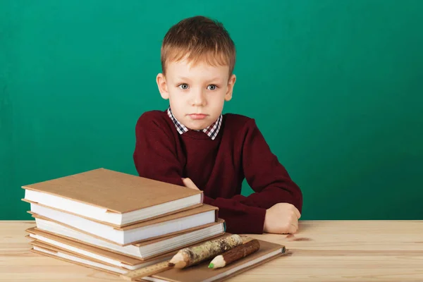 Young boy looking angry shaking his fists tired of school lesson — Stock Photo, Image