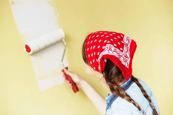 美丽的女孩在红色头巾画墙壁与油漆卷 — 图库照片