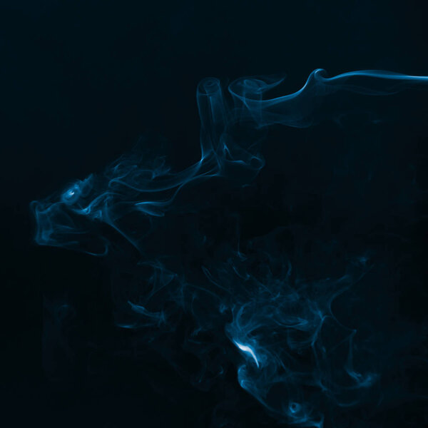Beautiful blue smoke against dark background