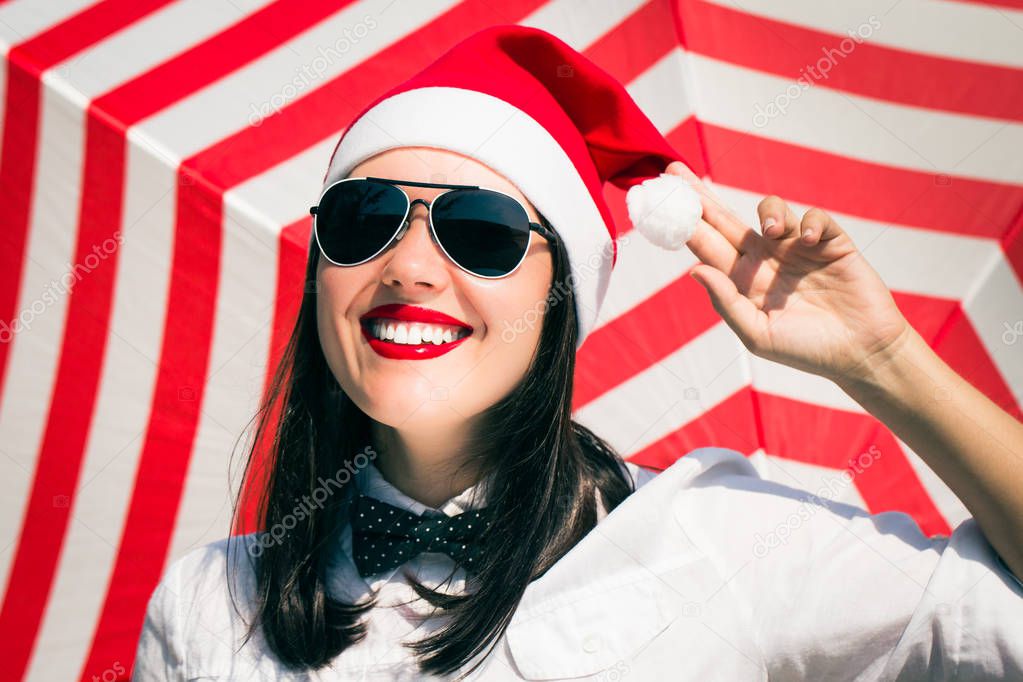 Portrait of a smiling pretty girl in Santa Claus hat