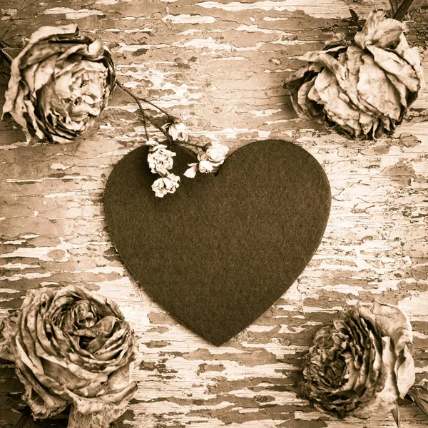 Kompozycja w stylu retro z filcu serca i wyblakłe róże — Zdjęcie stockowe