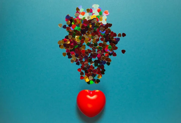 Decorative red heart with colorful confetti on blue background. — 스톡 사진