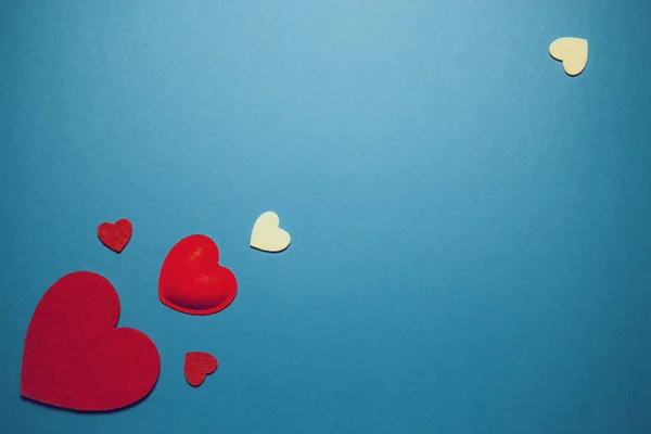 Decorative felt hearts on blue background. Abstract backdrop wit — 스톡 사진