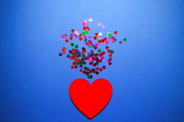 Decorative felt hearts with colorful confetti on blue background — 스톡 사진