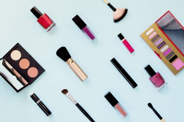 Renkli pastel arka planda makyaj fırçası ile dekoratif kozmetik seti. Asgari tarz kompozisyon. Üst görünüm