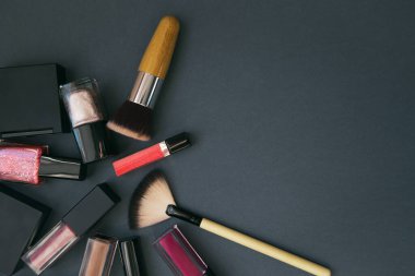 Karanlık arka planda dekoratif kozmetik seti. Asgari tarz kompozisyon. Güzellik ve makyaj konsepti. Üst Manzara. Düz yatıyordu. Seçici odak