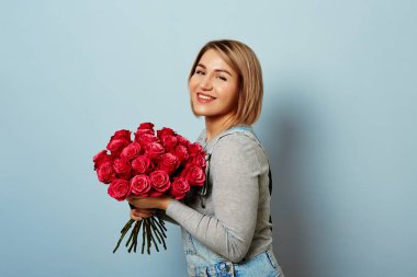 Beautiful girl in the overalls with red roses  clipart