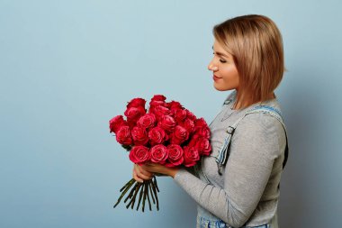 Beautiful girl in the overalls with red roses clipart