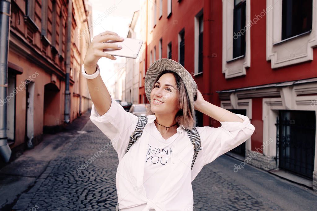 young female traveler taking selfie 