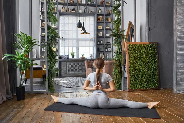 Mujer practicando yoga avanzado en la sala de estar — Foto de Stock