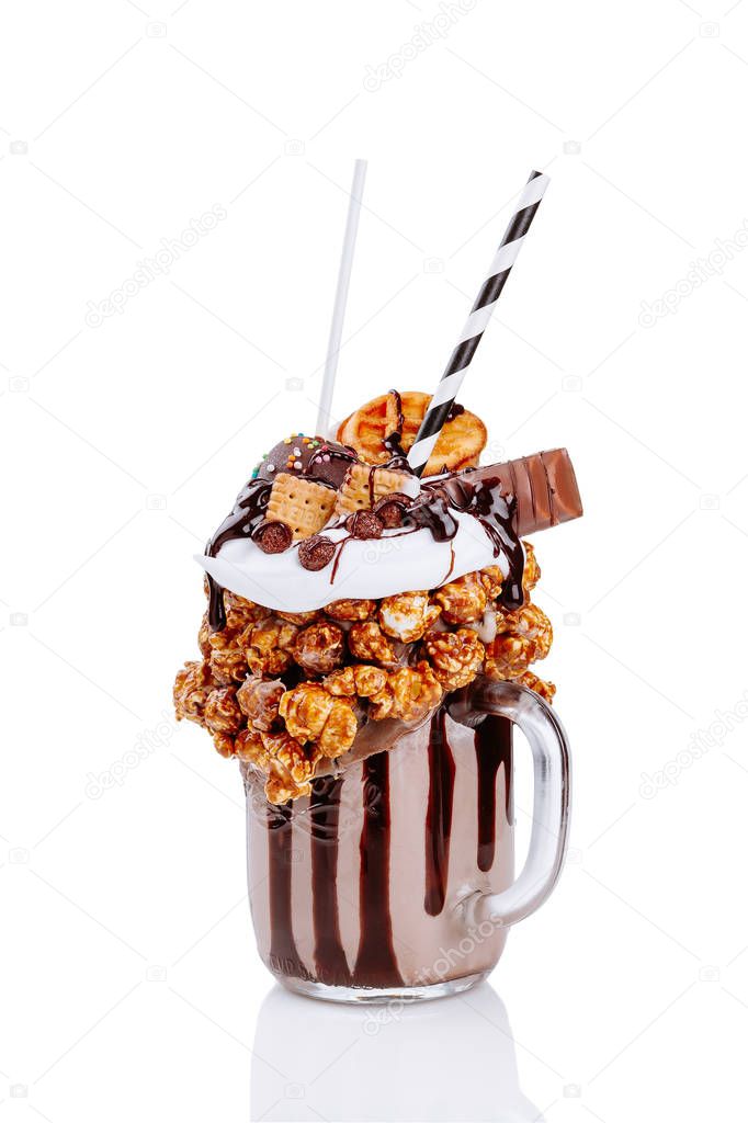 milkshake with chocolate, popcorn and sweets on white background
