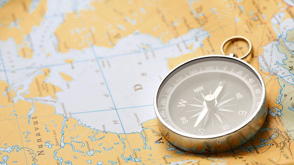 Close up of compass on tourist map background