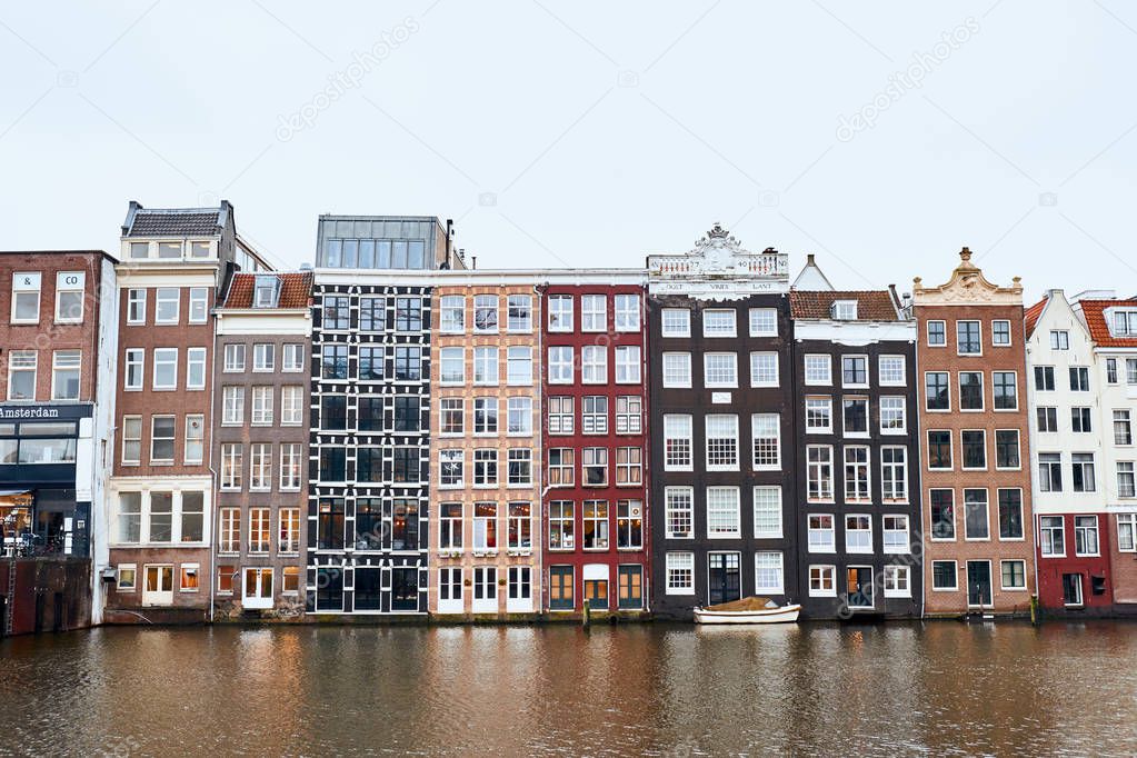  Front view of traditional old buildings along river in Amsterdam