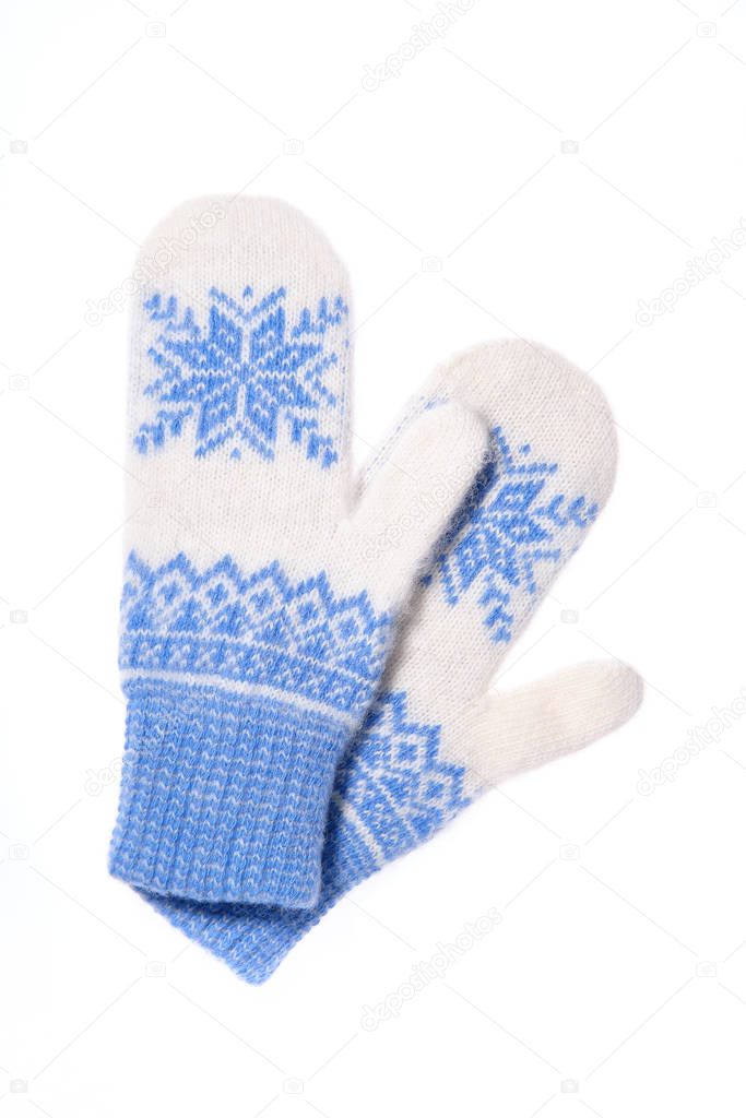 Warm woolen knitted mittens isolated on white background. Blue knitted mittens with pattern