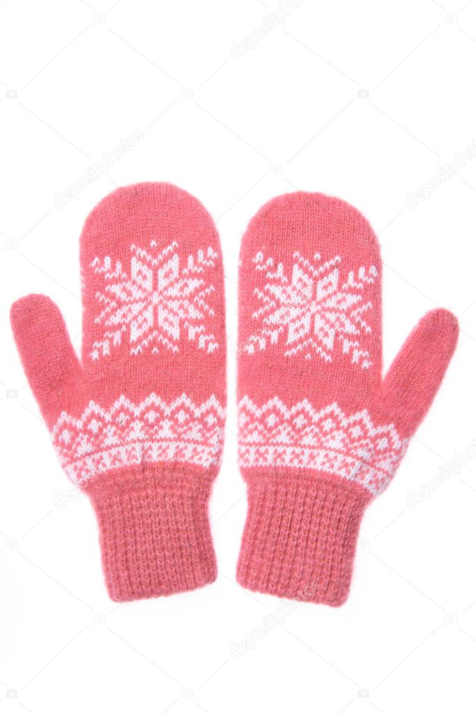 Warm woolen knitted mittens isolated on white background. Pink knitted mittens with pattern