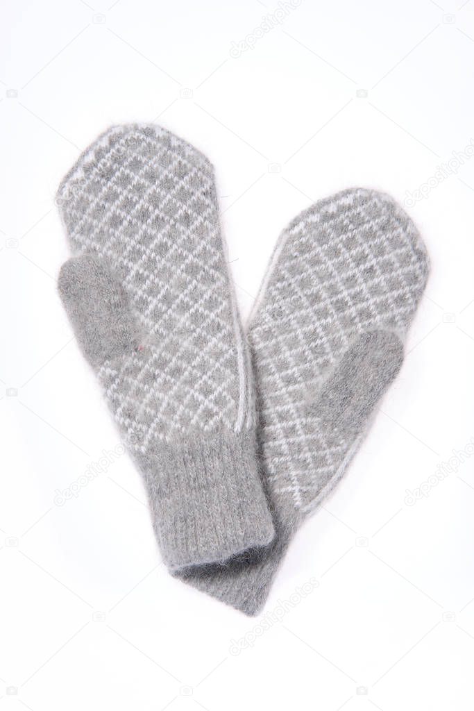 Warm woolen knitted mittens isolated on white background. Gray knitted mittens with pattern