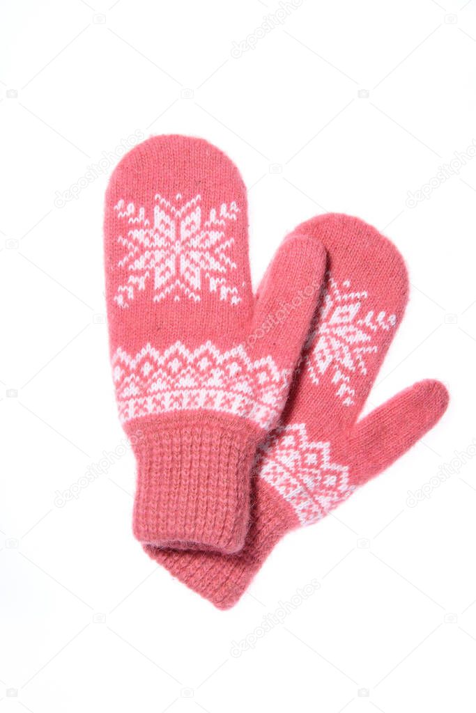 Warm woolen knitted mittens isolated on white background. Pink k