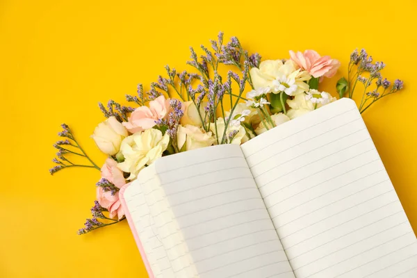 Bloc de notas rosa con flores sobre fondo amarillo. Humor de primavera — Foto de Stock