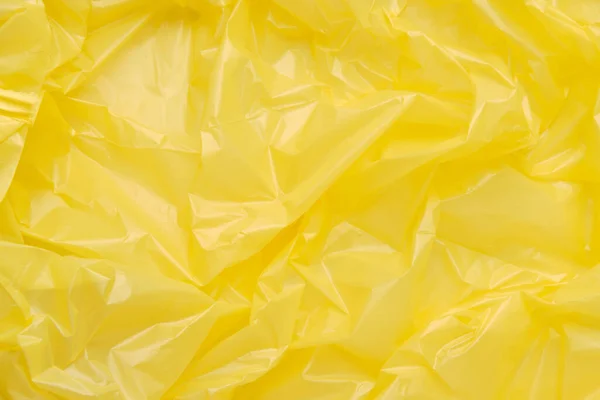 Zárja be a textúra egy sárga műanyag szemeteszsák. Sárga polieth — Stock Fotó