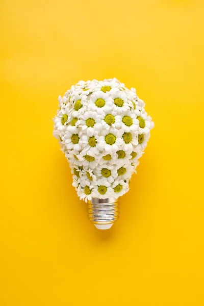 Energy Saving LED Lamp with Flowers over yellow background. Gree — Stock Photo, Image