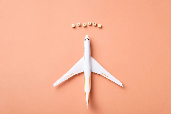 Airplane model and clouds. Text Travel. Fly by plane — Stock Photo, Image