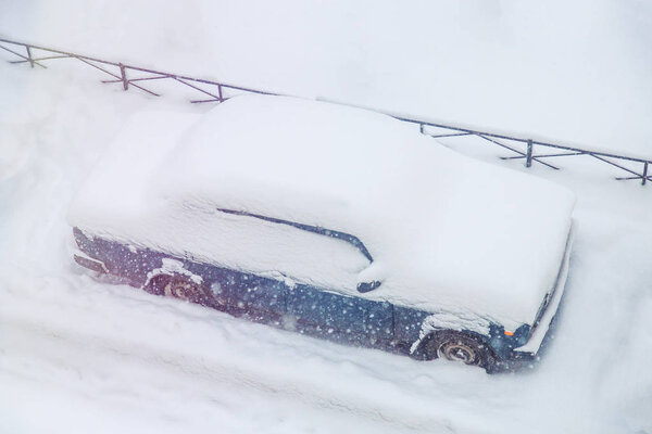 parked cars snowed during a snowfall