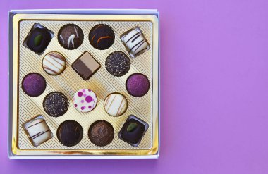 Pembe arkaplanda çikolatalı şeker kutusu. Sevgililer Günü ya da kopyalanmış doğum günü hediyesi konsepti. Seçmeli odak noktası..