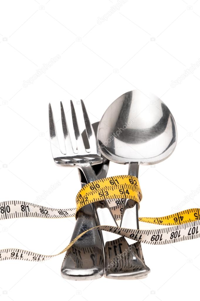 Cutlery wrapped with a tape measure, symbol for a diet